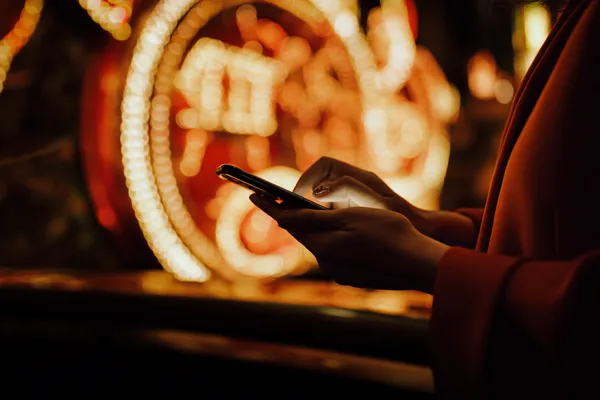BEFWAY App — Fast, responsive, and optimized for all devices A cheerful woman in traditional clothing using her smartphone during a festive moment, showing how easily the BEFWAY app fits into everyday life.